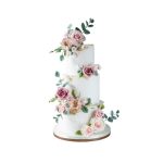 3-Tier Vanilla Wedding Cake with Swiss Meringue Buttercream Frosting, adorned with pinkish roses and greenery – Serves 70-80